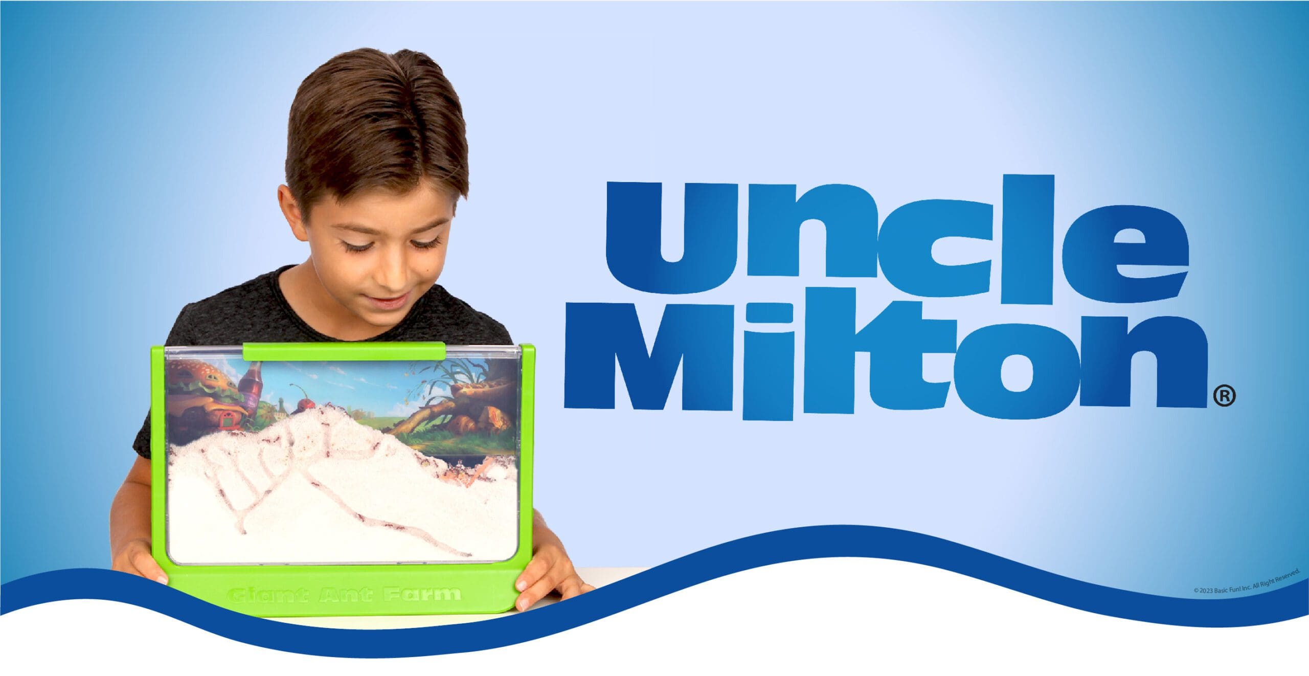 Uncle Milton banner showing a boy playing with ant farm