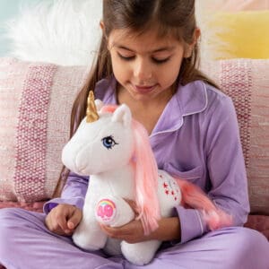 Girl with white plush unicorn with pink hair