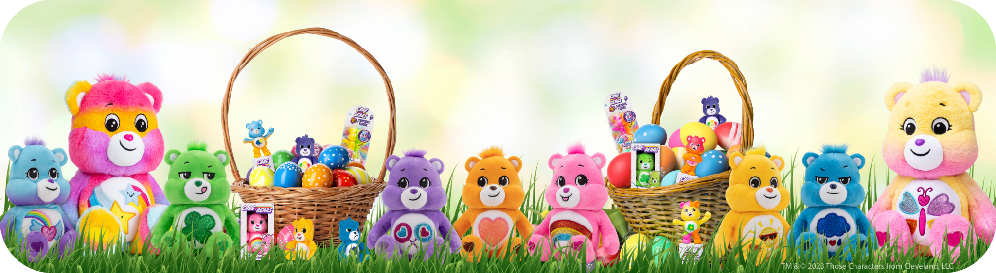 Easter banner showing a line of care bears arranged in a grass setting with eggs and baskets.