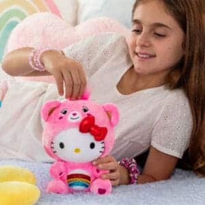 Young girl playing with Plush Hello Kitty dressed as Cheer Bear.